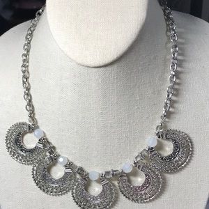 NY Silver tone statement necklace features upward moon shapes on chunky chain